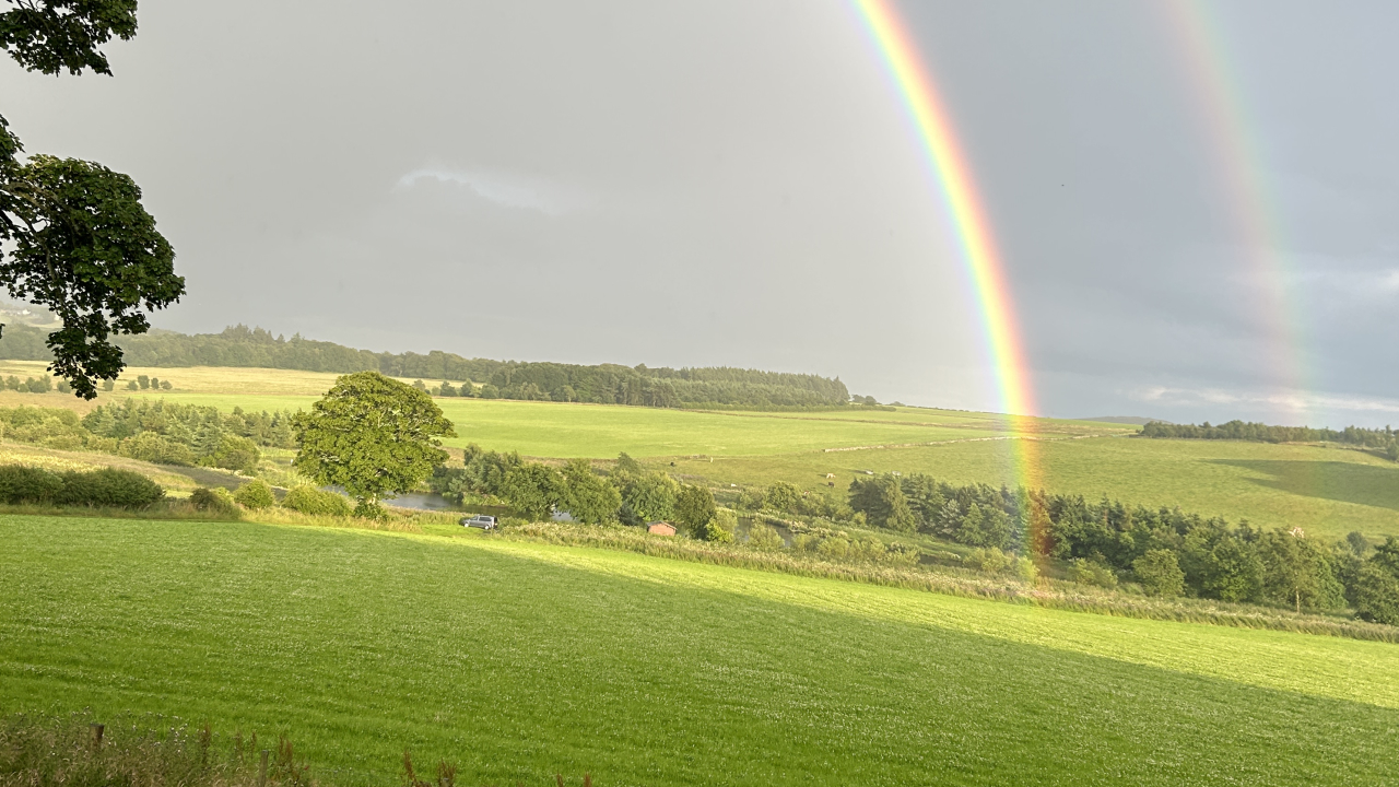 Rainbow over a field in Scotland.